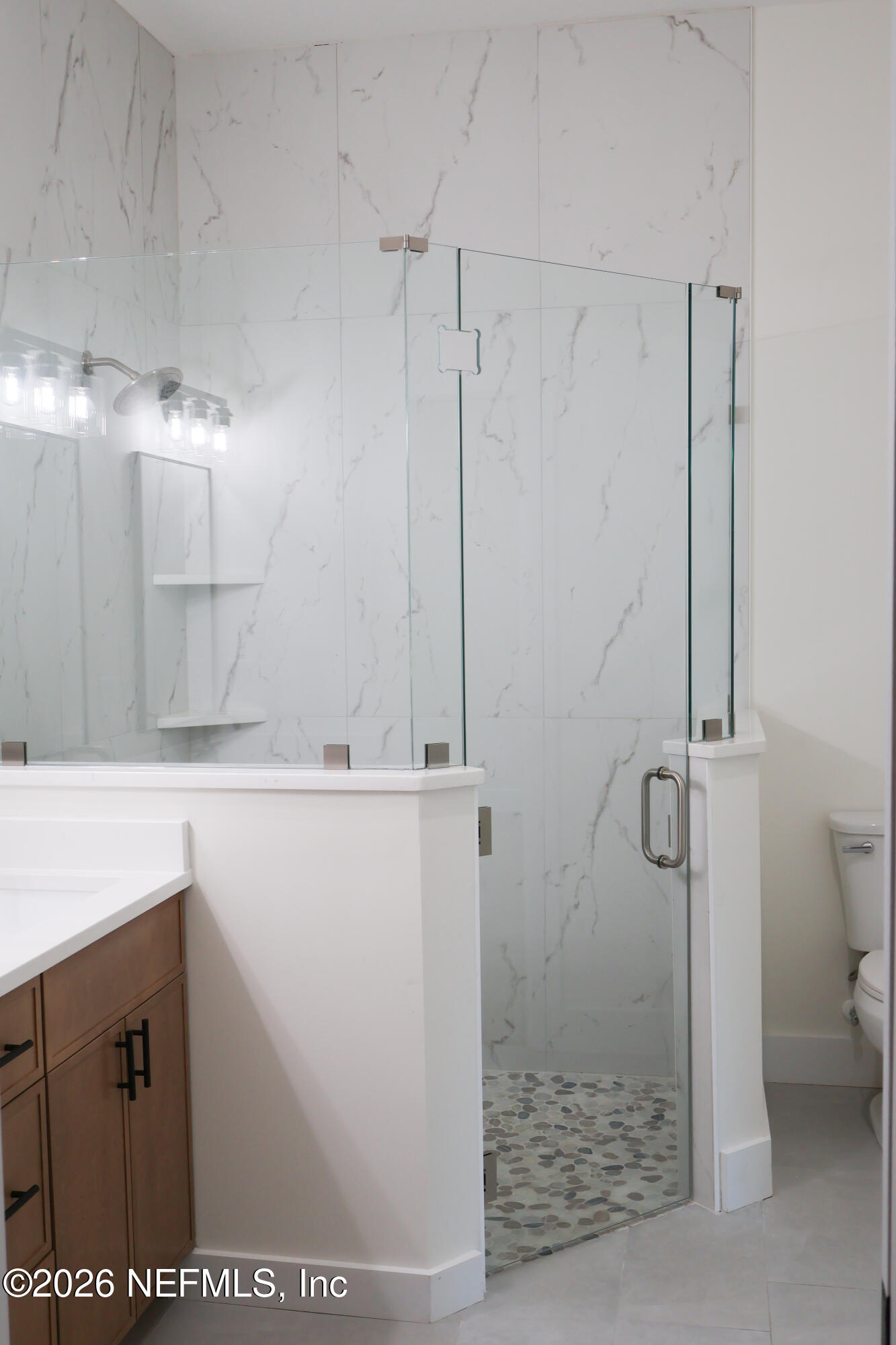 261121 Rowe Road Hilliard, FL 32046 - Photo 7 of 33 a bathroom with a shower and a sink