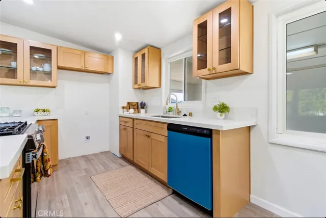 a kitchen with stainless steel appliances granite countertop a sink stove and cabinets