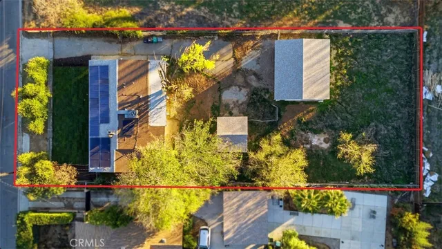an aerial view of a house with a yard and garden