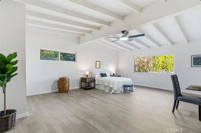 a bedroom with a bed and a ceiling fan