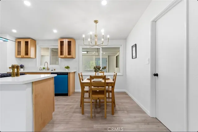 a view of a dining room with furniture and chandelier