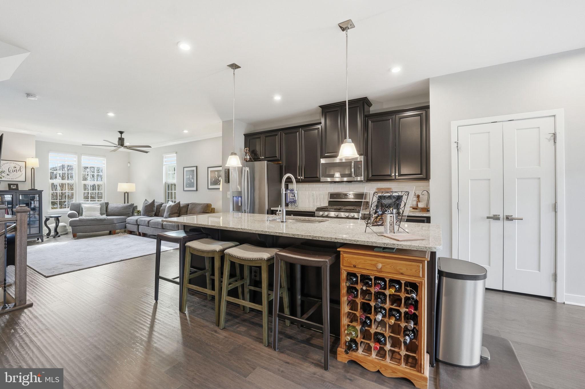 18112 Red Cedar Road Dumfries, VA 22026 - Photo 15 of 69 a kitchen with stainless steel appliances granite countertop a table chairs sink and cabinets
