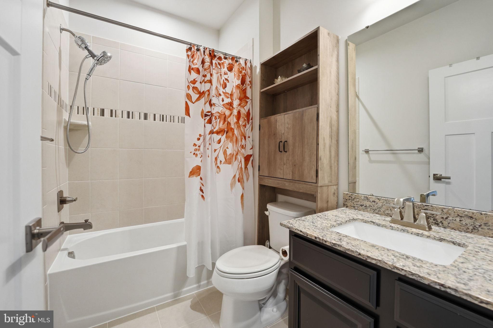 18112 Red Cedar Road Dumfries, VA 22026 - Photo 27 of 69 a bathroom with a granite countertop sink toilet and shower