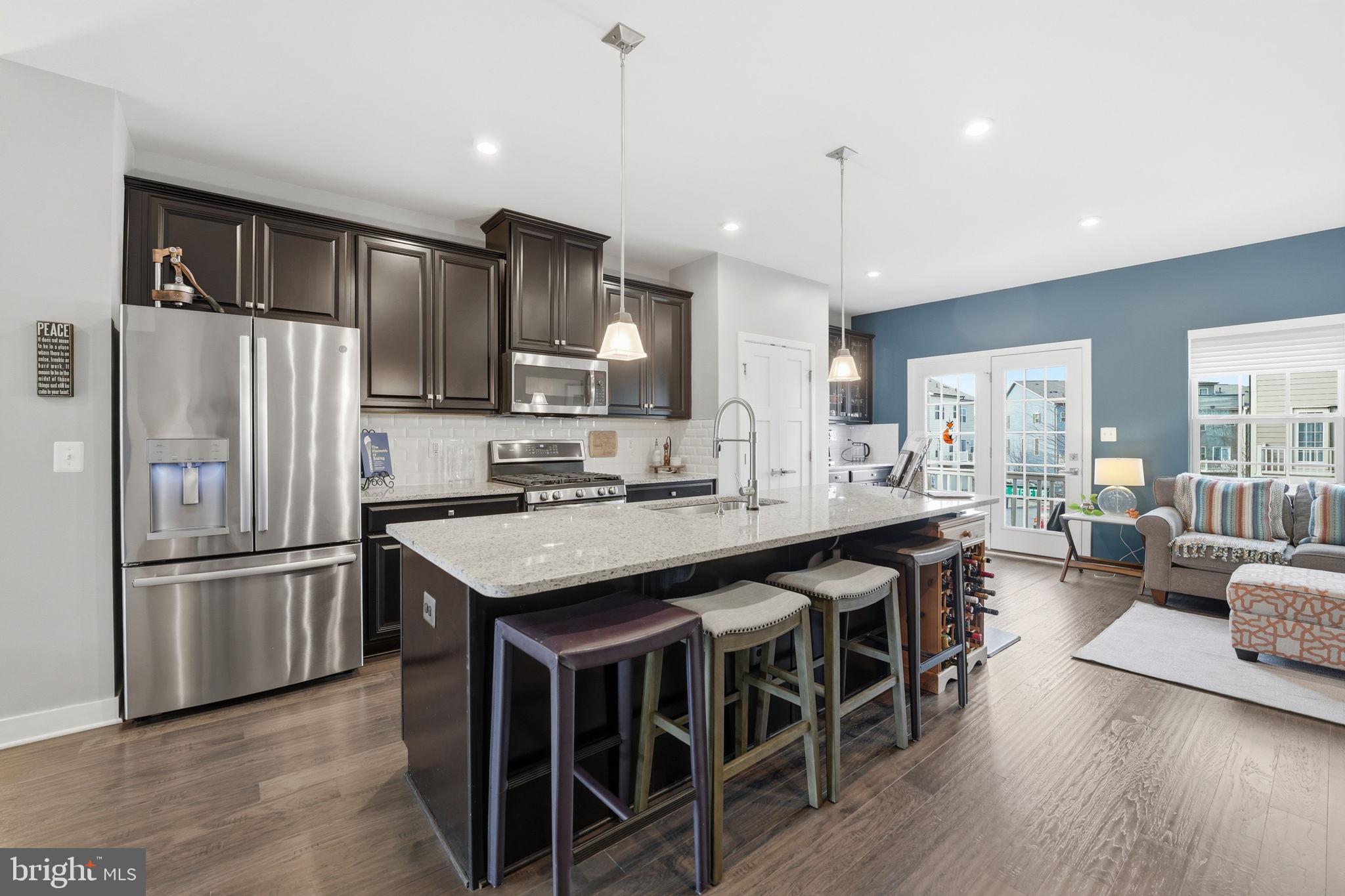 18112 Red Cedar Road Dumfries, VA 22026 - Photo 6 of 69 a kitchen with kitchen island granite countertop a center island stainless steel appliances cabinets and a counter top space