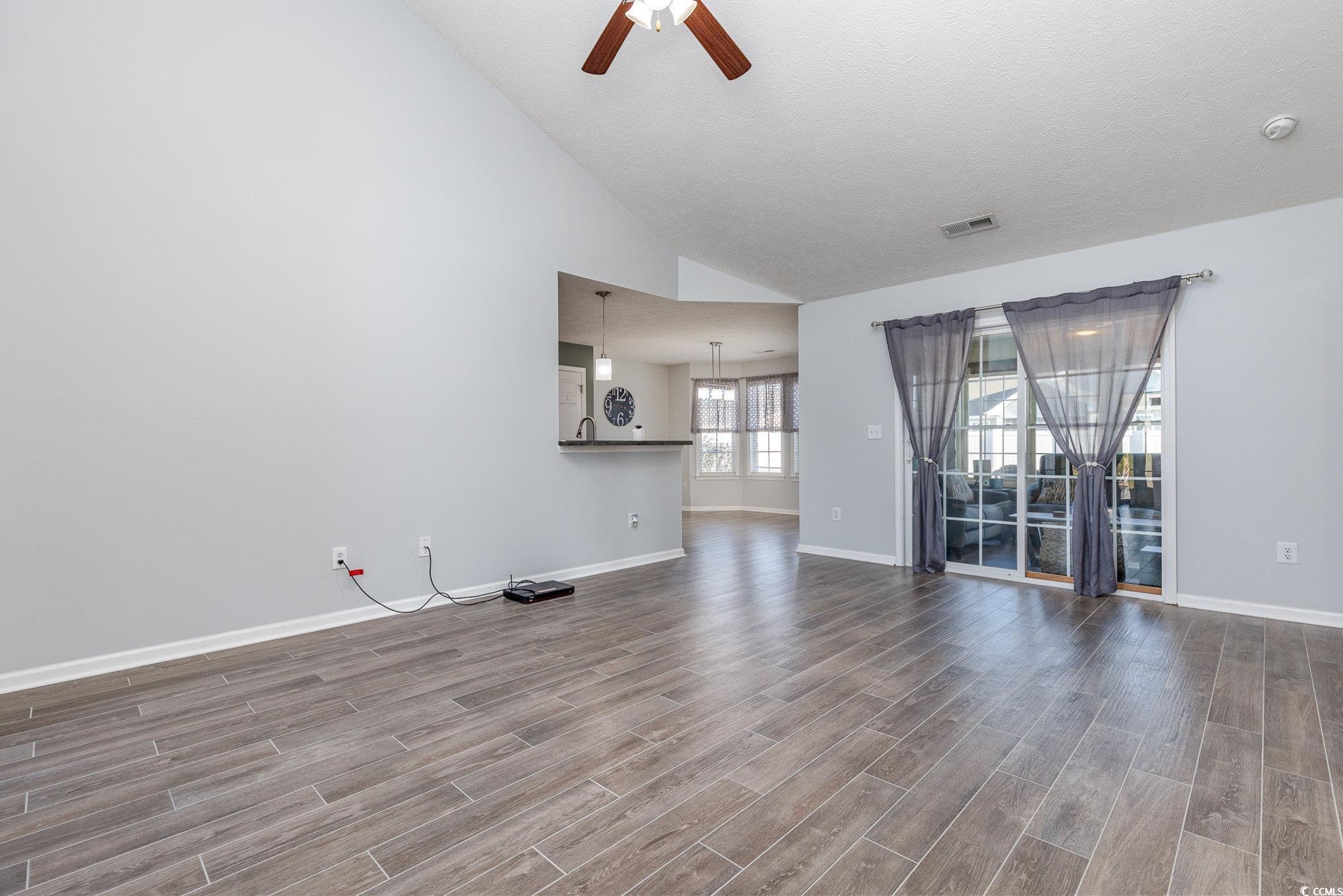 295 Four Leaf Lane Murrells Inlet, SC 29576 - Photo 9 of 32 Unfurnished living room with ceiling fan and high