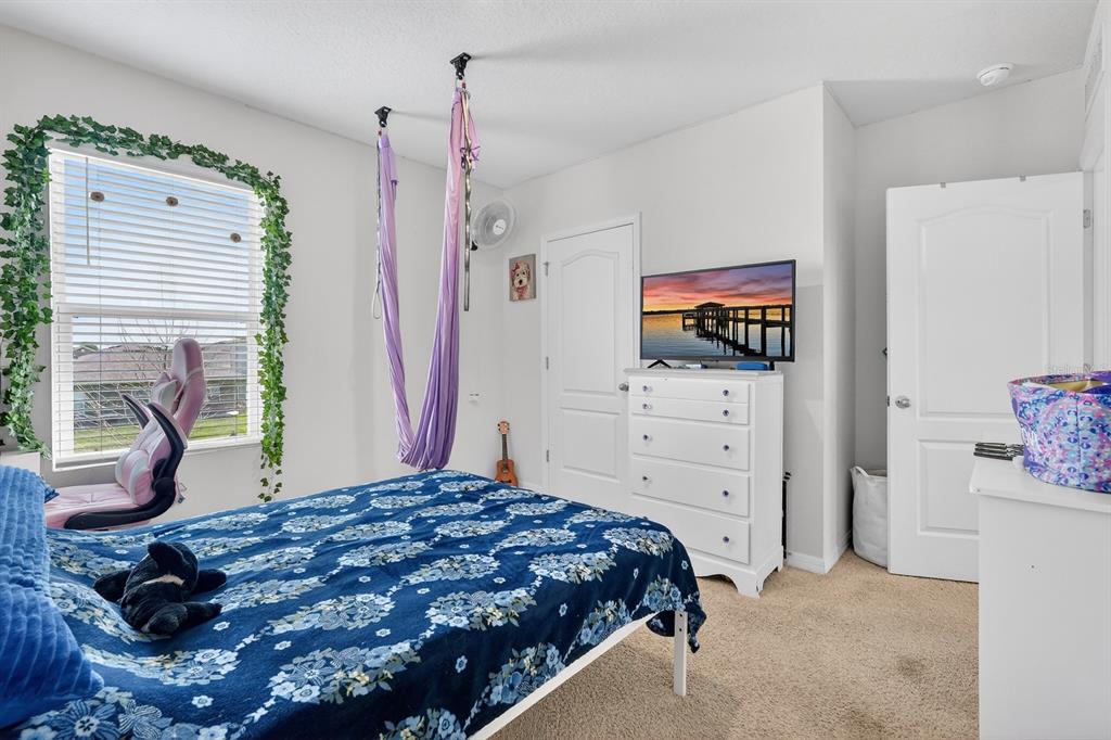 1809 Myrtlebrooke Drive Edgewater, FL 32141 - Photo 26 of 58 a bedroom with a bed and a flat screen tv