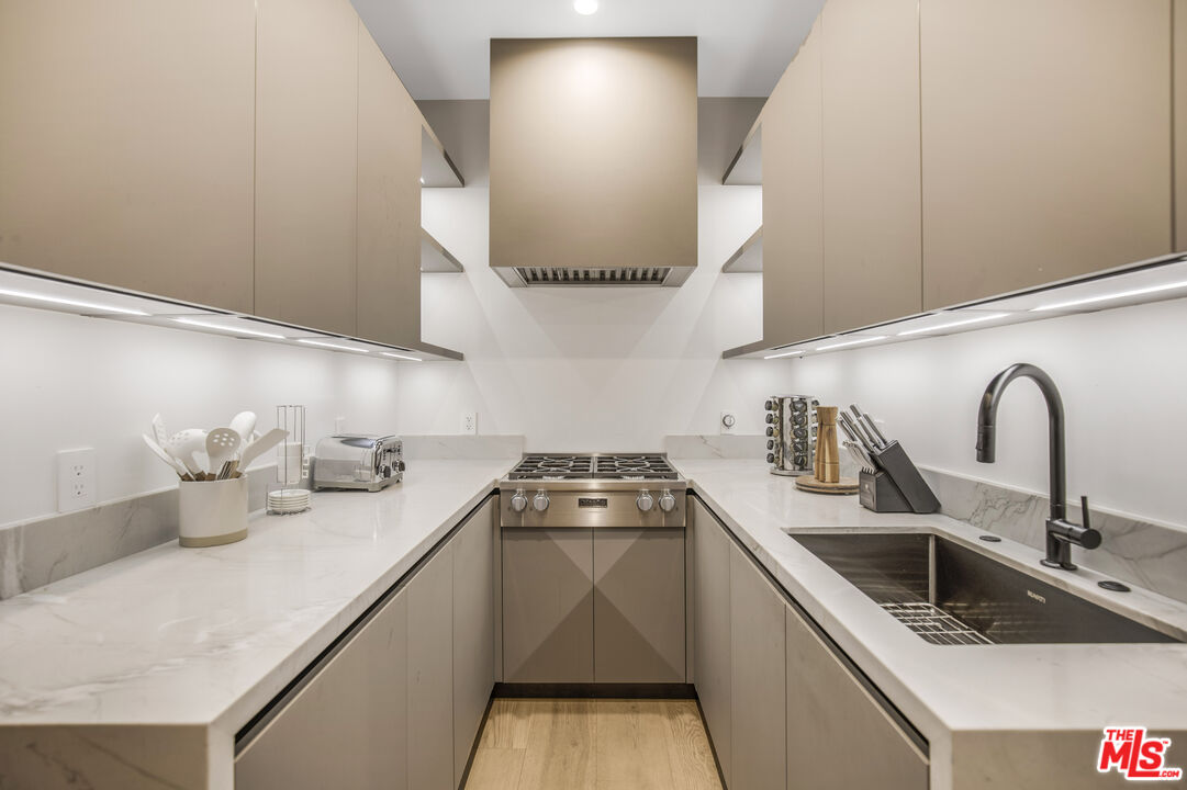4246 Levitt Lane Sherman Oaks, CA 91403 - Photo 19 of 63 a kitchen with a sink a stove and cabinets