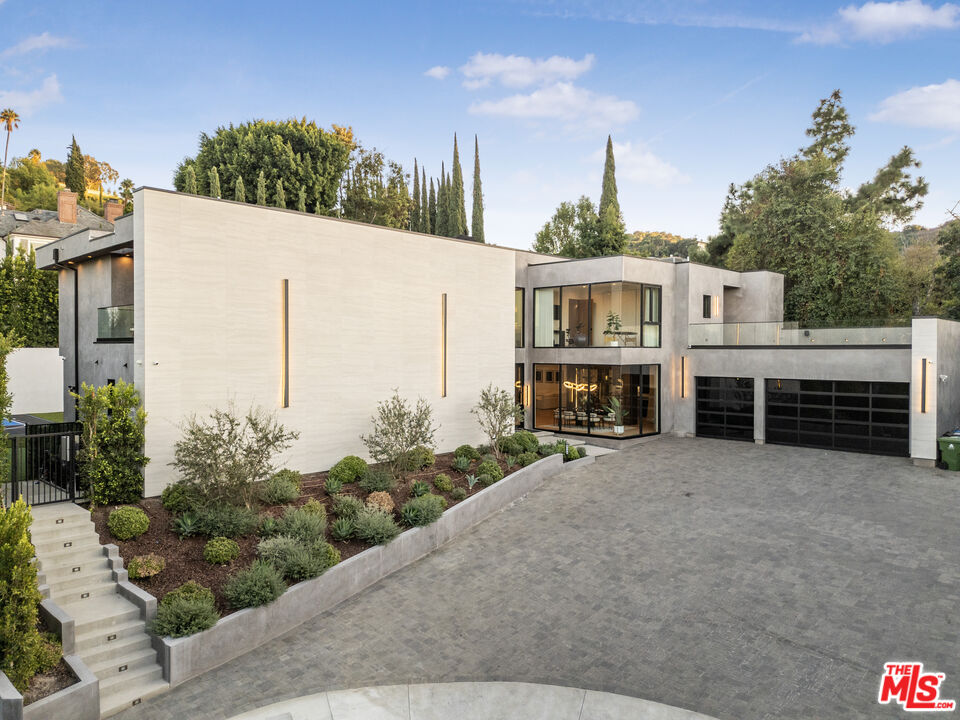 4246 Levitt Lane Sherman Oaks, CA 91403 - Photo 3 of 63 a front view of a house with a yard and garage