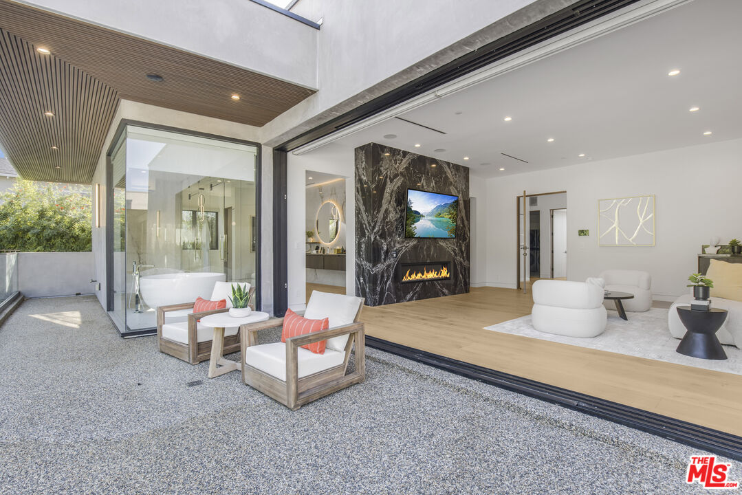 4246 Levitt Lane Sherman Oaks, CA 91403 - Photo 31 of 63 a living room with furniture and a floor to ceiling window