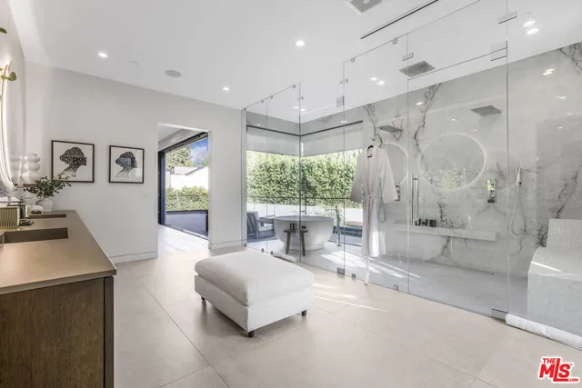 a bedroom with a large bed and a balcony