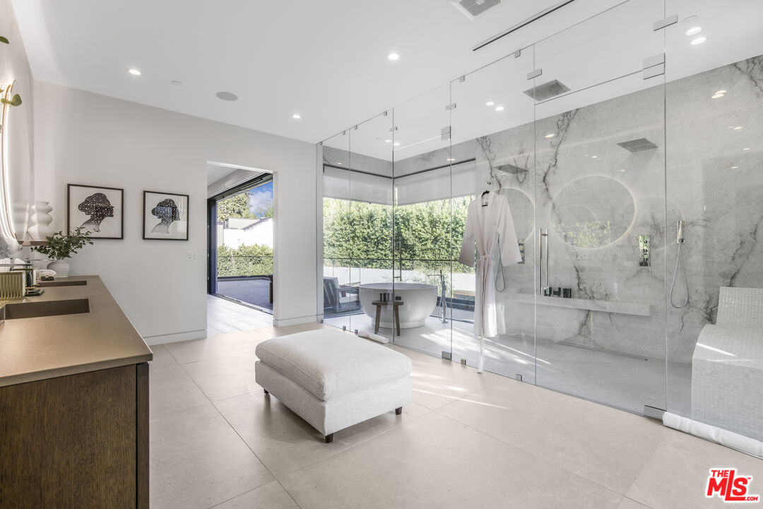 4246 Levitt Lane Sherman Oaks, CA 91403 - Photo 33 of 63 a spacious bedroom with a large bed and a large window