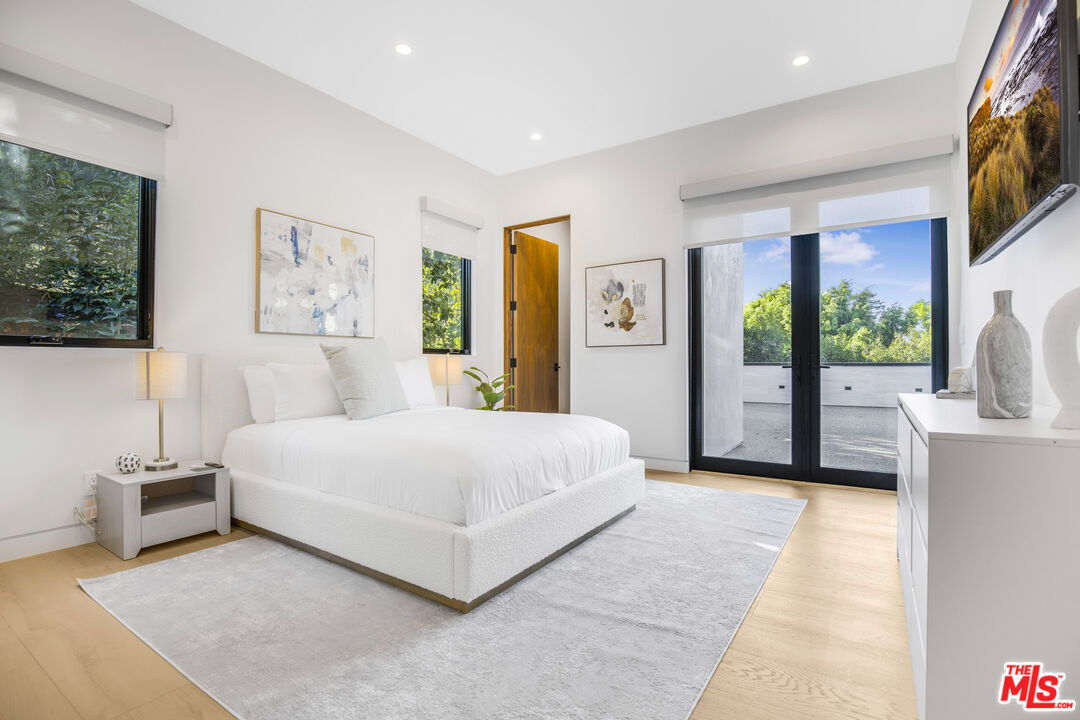 4246 Levitt Lane Sherman Oaks, CA 91403 - Photo 36 of 63 a spacious bedroom with a large bed and a flat tv screen on dresser