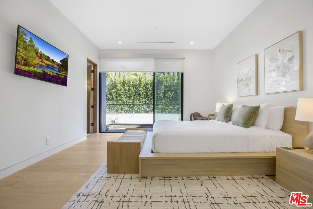 4246 Levitt Lane Sherman Oaks, CA 91403 - Photo 39 of 63 a spacious bedroom with a large bed and a couch