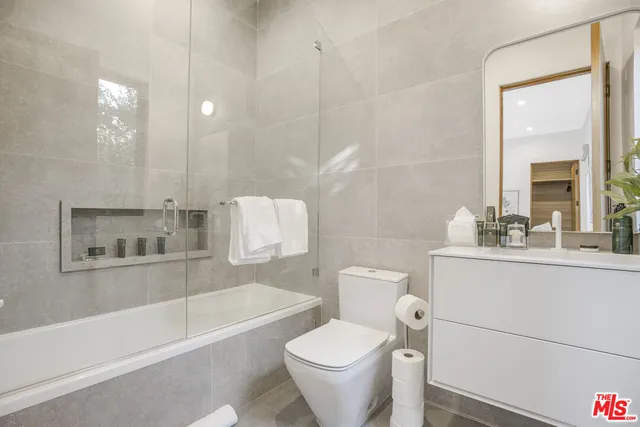 a view of a roof deck with couches and potted plants