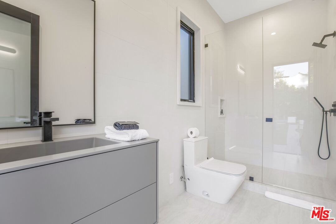 4246 Levitt Lane Sherman Oaks, CA 91403 - Photo 46 of 63 a bathroom with a sink a toilet and shower