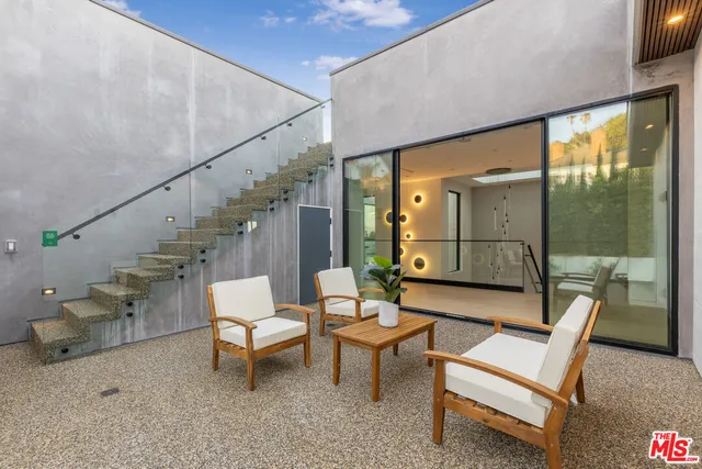 a dining room with furniture and a floor to ceiling window
