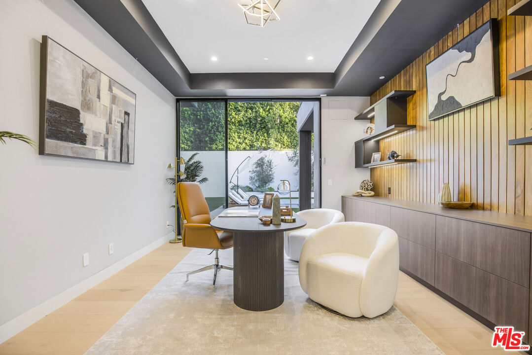 4246 Levitt Lane Sherman Oaks, CA 91403 - Photo 5 of 63 a dining room with fireplace furniture and a large window