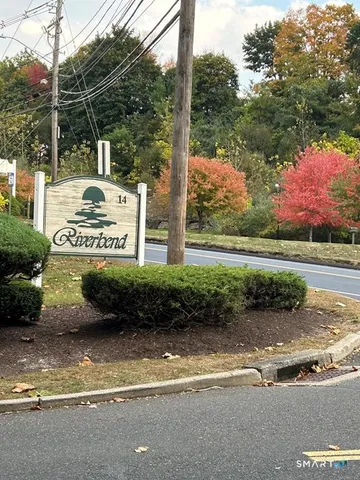a view of a street with a car parked on the road