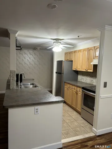 a kitchen with stainless steel appliances granite countertop a sink and a stove