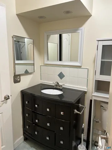 a bathroom with a granite countertop sink a mirror and a