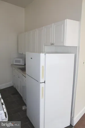 a white refrigerator freezer sitting inside of a kitchen