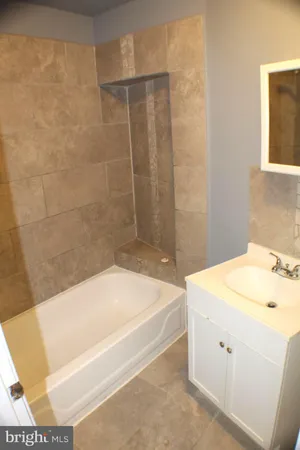 a bathroom with a sink a bathtub and a shower
