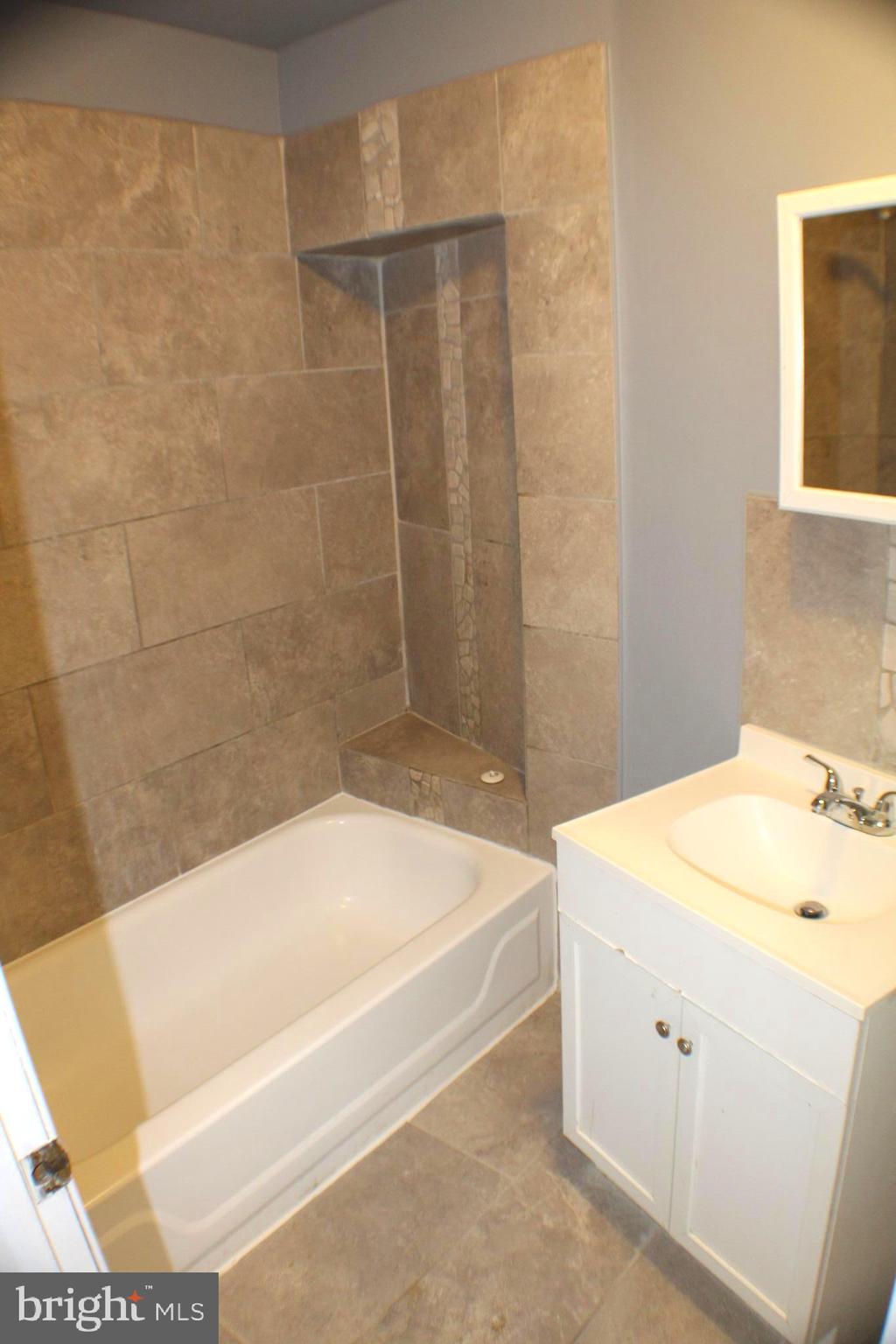 4417 Baker Street, Unit 1 Philadelphia, PA 19127 - Photo 6 of 11 a bathroom with a sink a bathtub and a shower