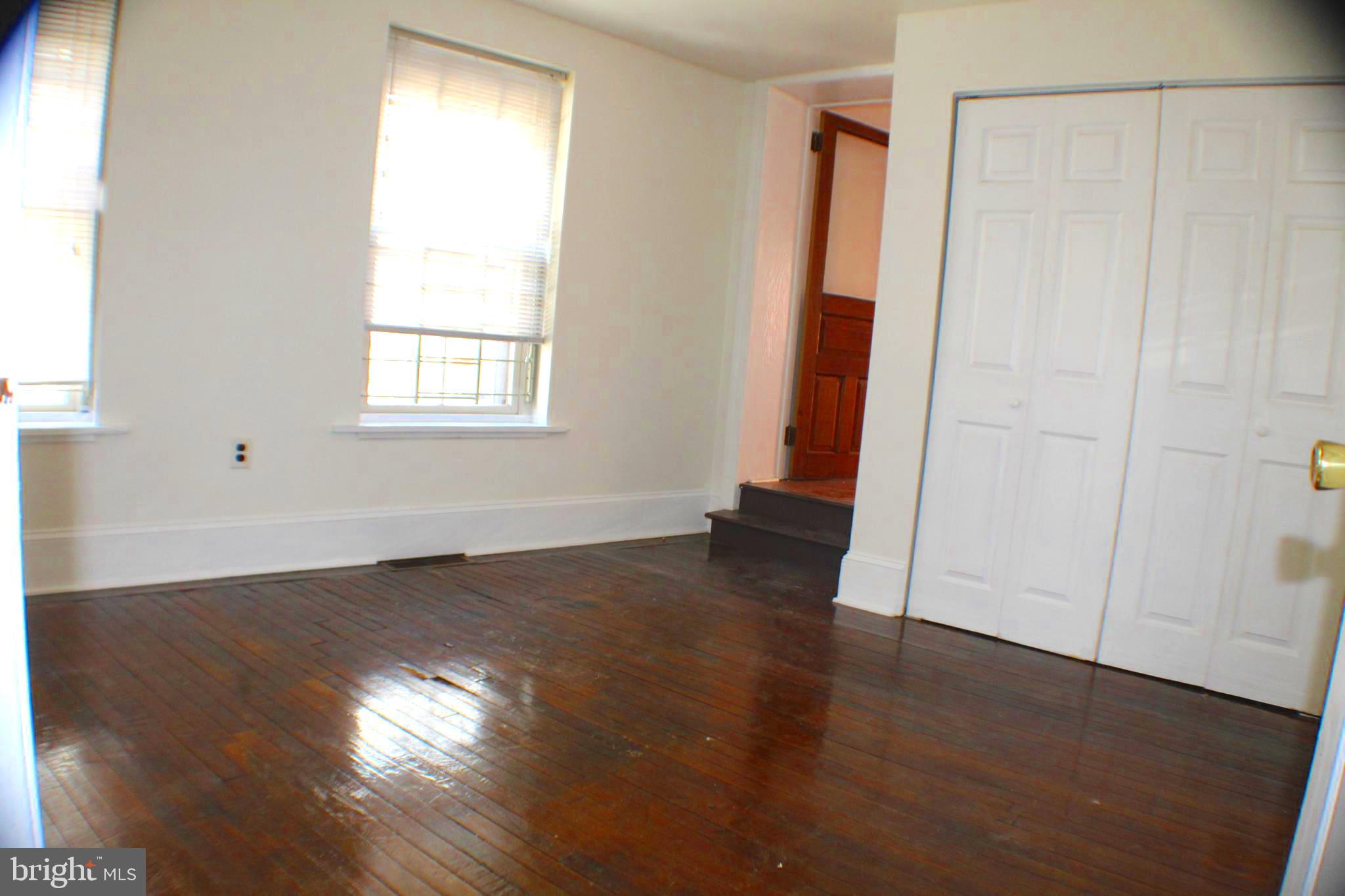 4417 Baker Street, Unit 1 Philadelphia, PA 19127 - Photo 8 of 11 an empty room with wooden floor and windows