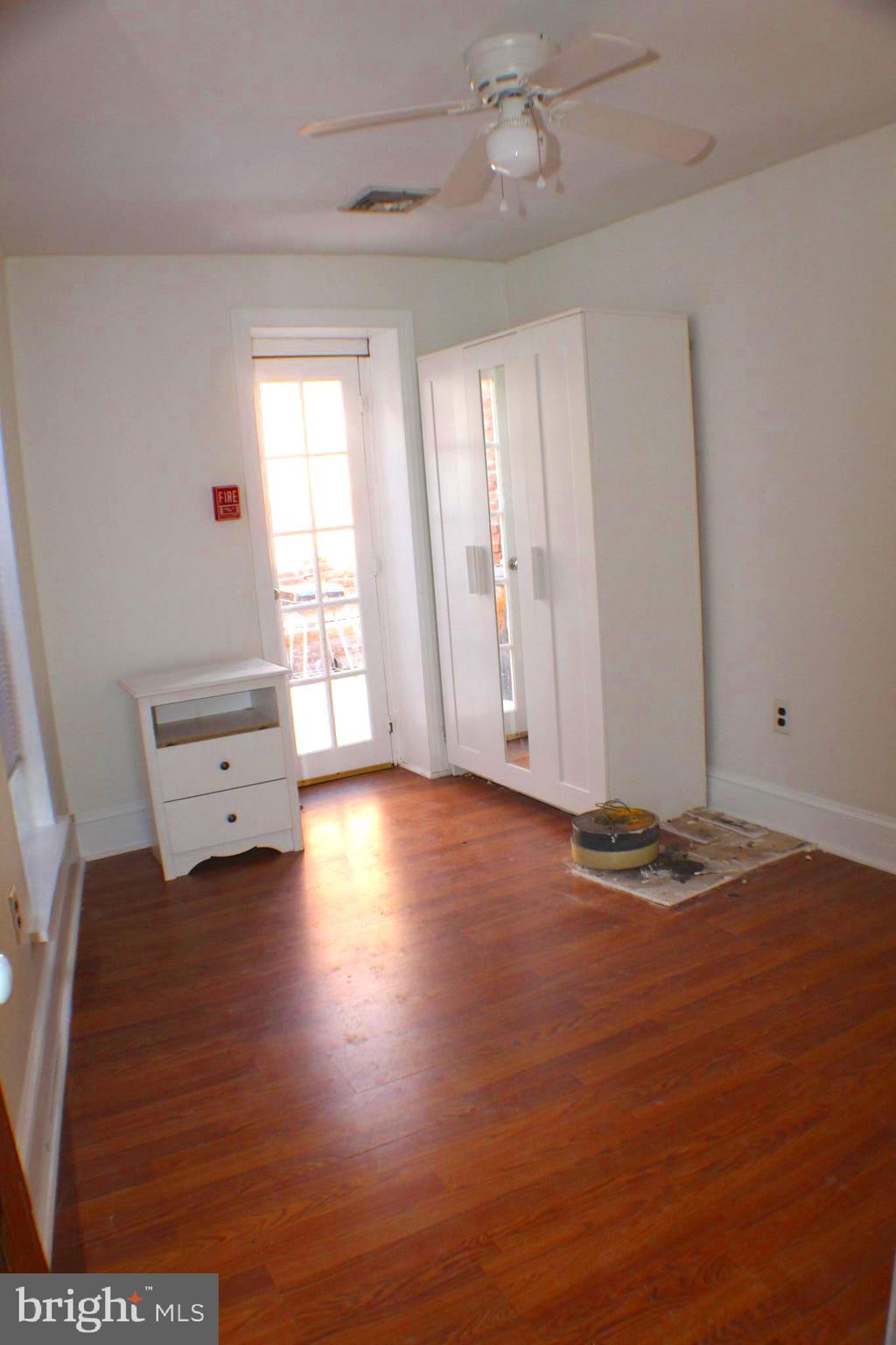 4417 Baker Street, Unit 1 Philadelphia, PA 19127 - Photo 9 of 11 a view of empty room with wooden floor and fan