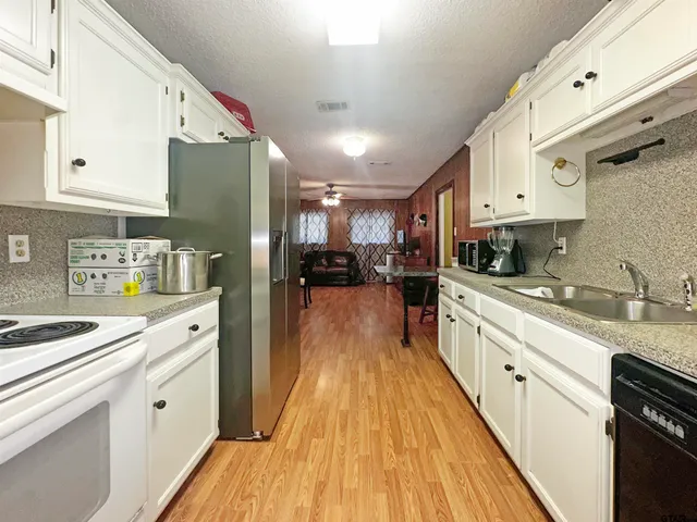 a kitchen with cabinets a sink and appliances