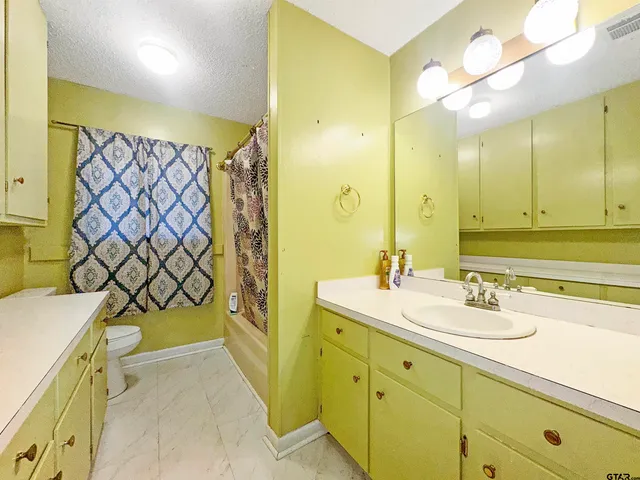 a bathroom with a sink mirror and a bathtub