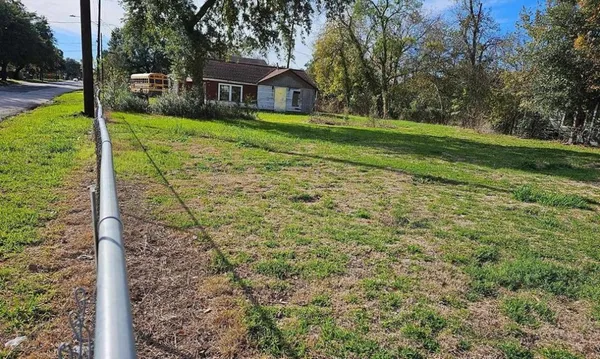 a view of a house with a yard and tree s