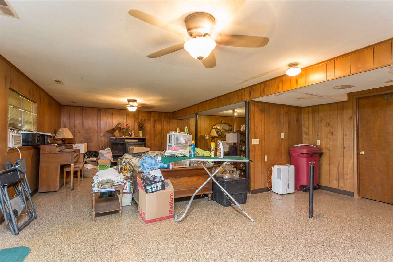 4627 Timber Ridge Road Mount Crawford, VA 22841 - Photo 37 of 42 a room with gym equipment and a chandelier
