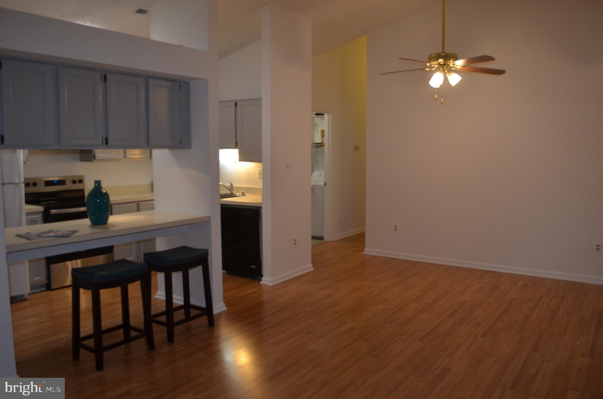 2137 Wainwright Court, Unit 2D Frederick, MD 21702 - Photo 31 of 31 a kitchen with granite countertop a stove cabinets and wooden floor