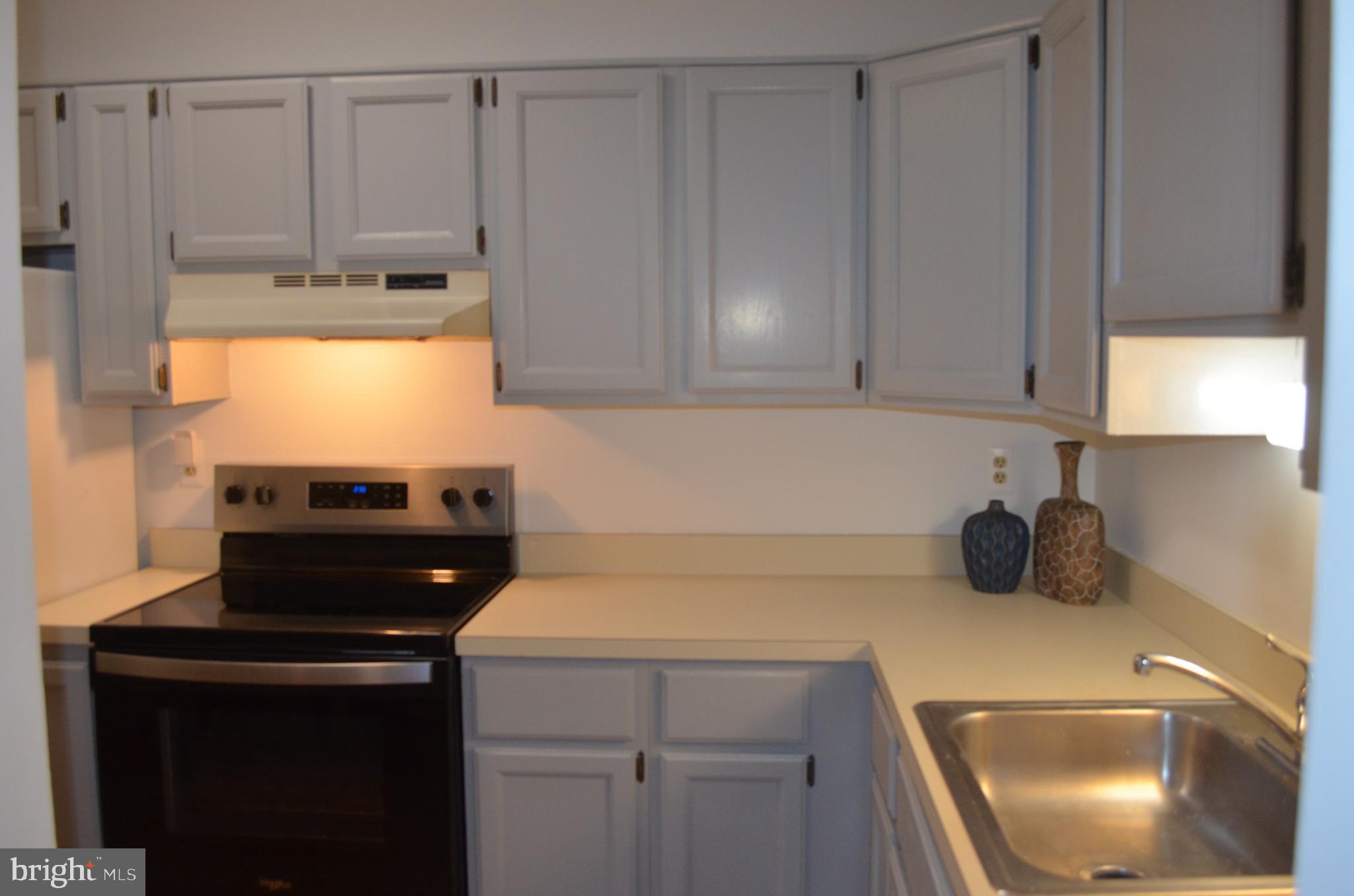 2137 Wainwright Court, Unit 2D Frederick, MD 21702 - Photo 12 of 31 a kitchen with a sink cabinets and appliances