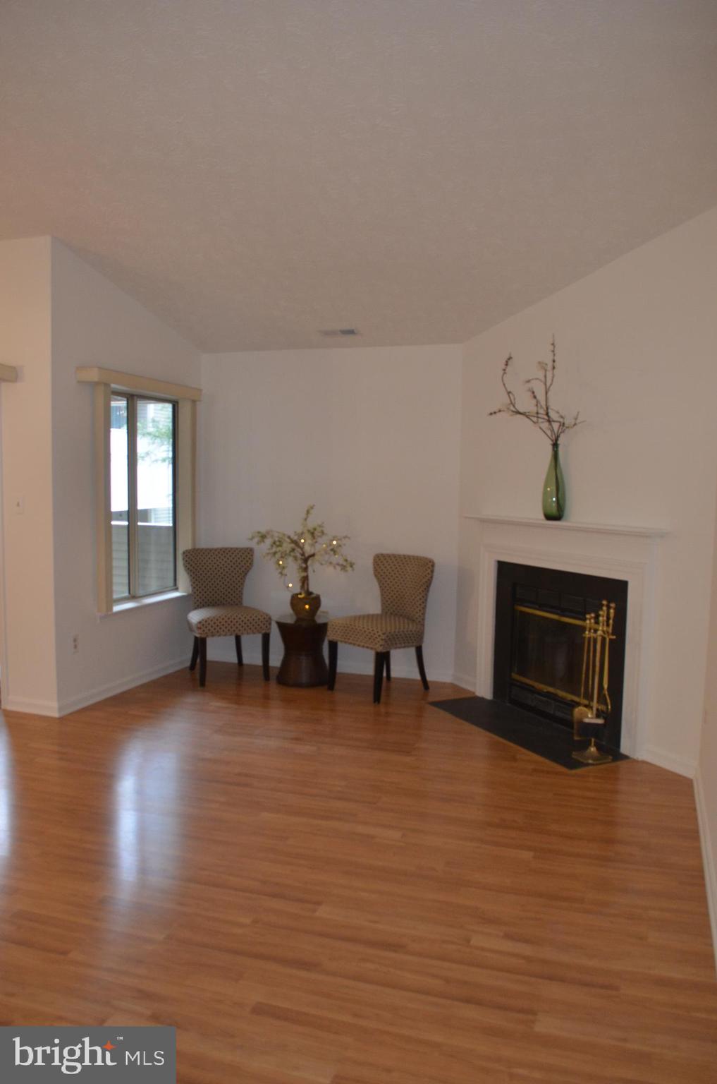 2137 Wainwright Court, Unit 2D Frederick, MD 21702 - Photo 4 of 31 a living room with furniture and a fireplace