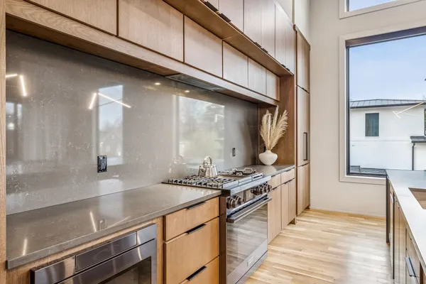 a kitchen with stainless steel appliances granite countertop a sink and a stove