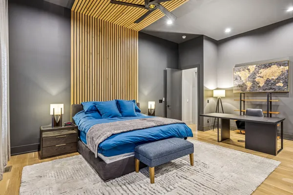 a bedroom with a bed and glass windows