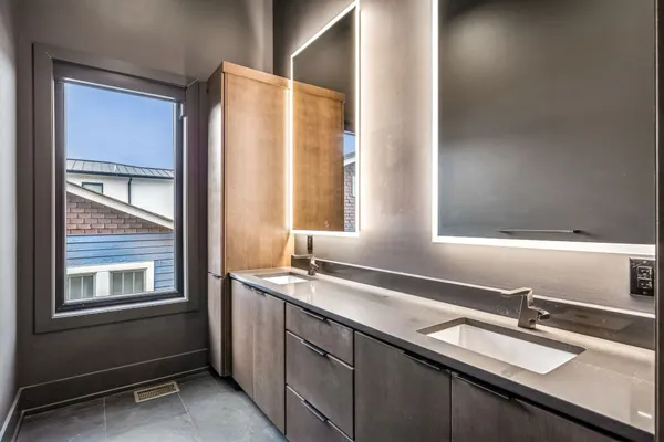 a bathroom with a double vanity sink and mirror
