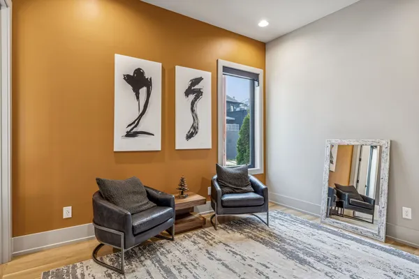a living room with furniture a rug and a window