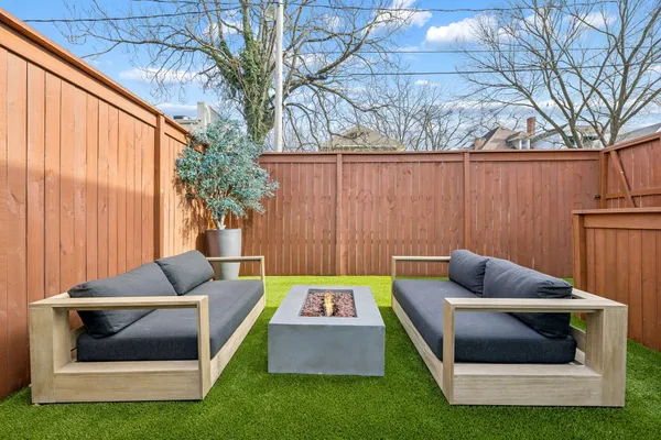 an outdoor sitting area with furniture and garden