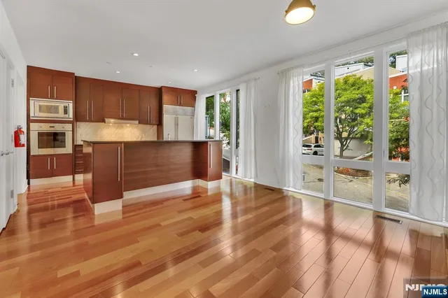 a kitchen with granite countertop a sink and wooden cabinets