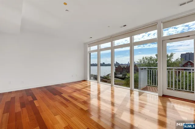 a view of a room with wooden floor and white walls