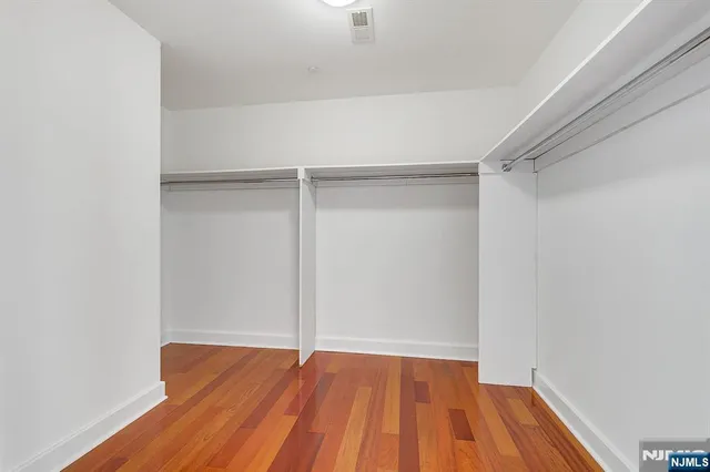 a spacious bathroom with a double vanity sink a toilet and a bathtub