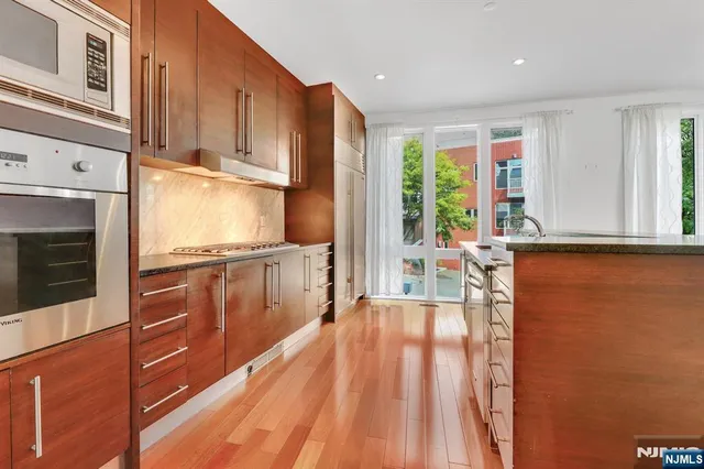 a view of kitchen with wooden floor and electronic appliances