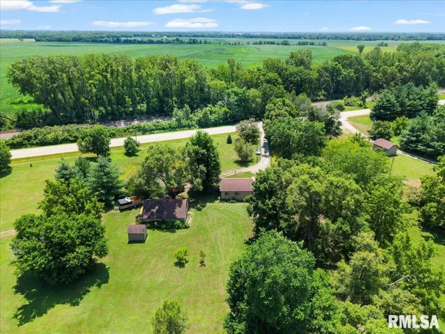 an aerial view of a houses with a yard and lake view