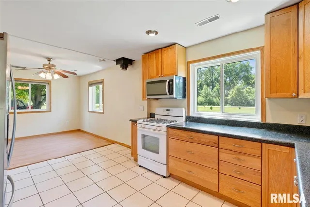 a kitchen with stainless steel appliances granite countertop a stove and a sink
