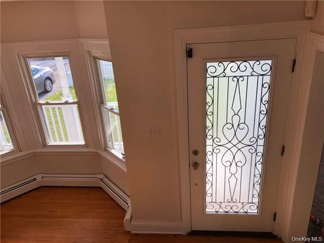 a view of an entryway with wooden floor