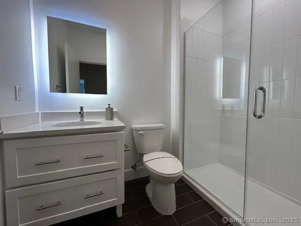 a bathroom with a toilet sink and shower