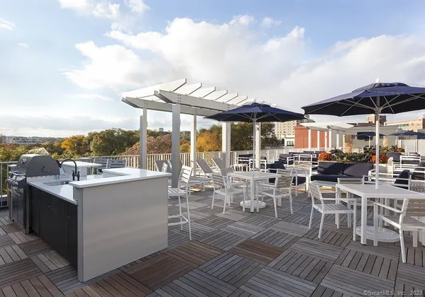a view of a patio with dining table and chairs with wooden floor